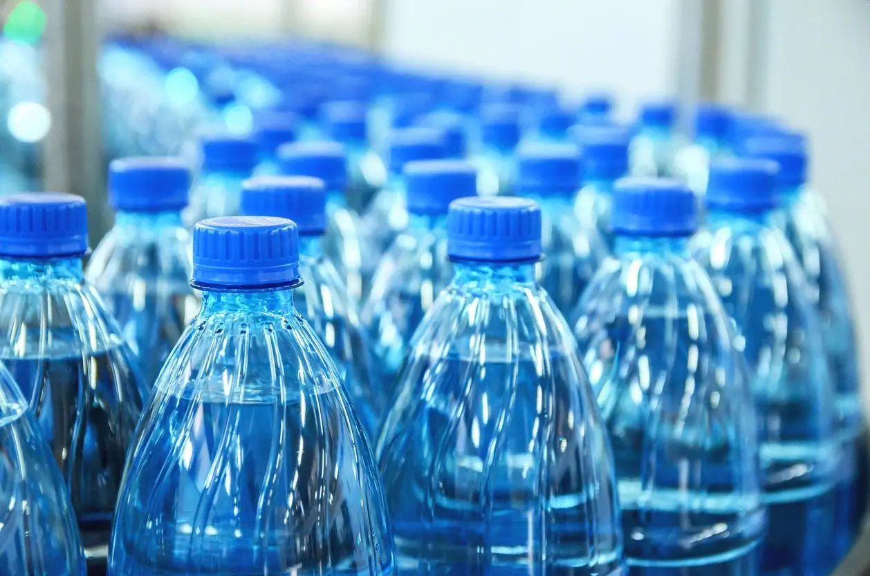A close up of many blue plastic bottles
