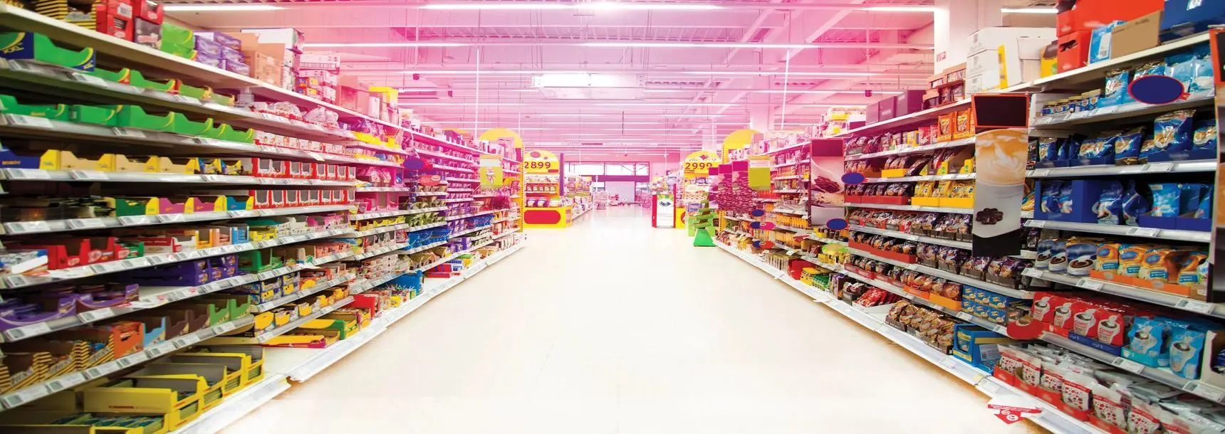 A supermarket with many shelves of food and toys.