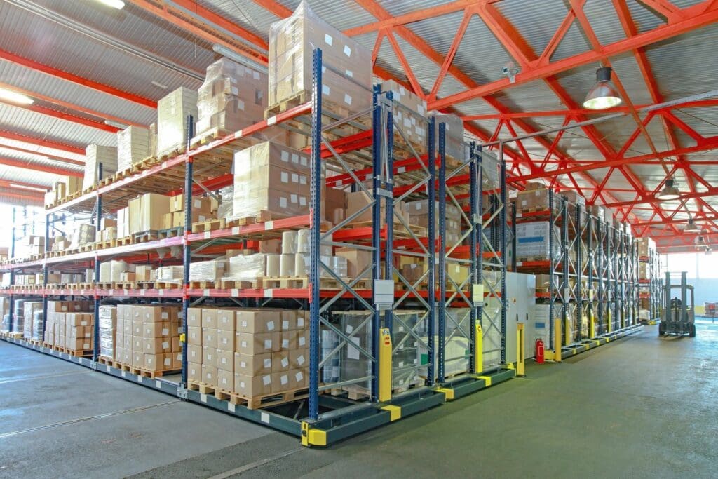 A warehouse with many racks of boxes on it.
